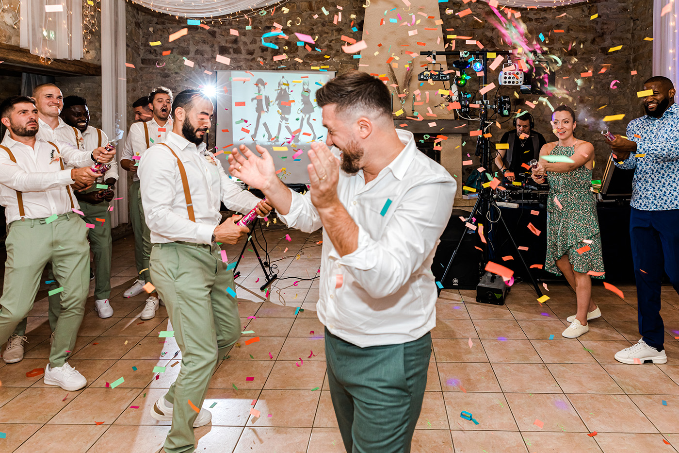 Le marié sous les confettis pendant la soirée de mariage