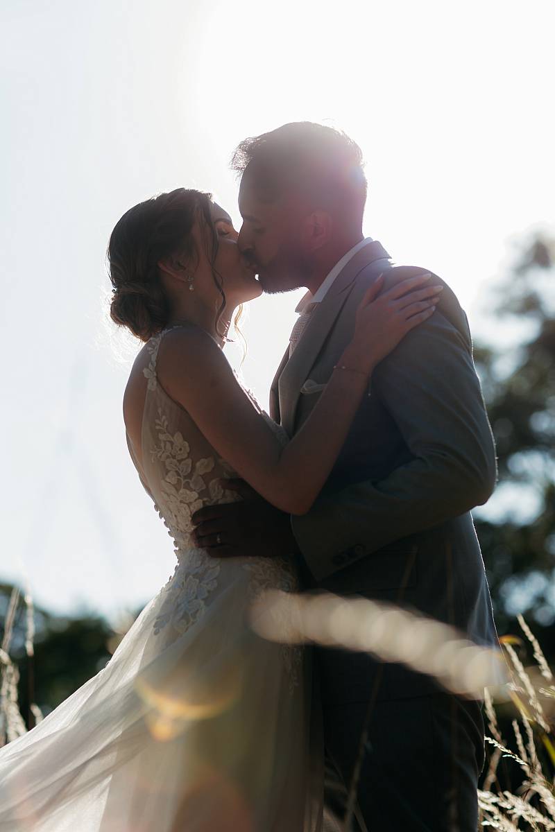Moment de tendresse des mariés à contre jour