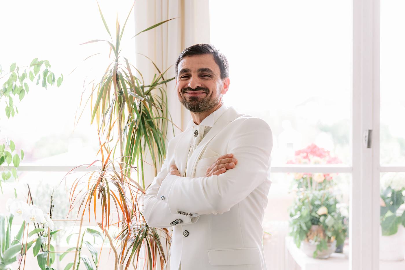 Le marié prend la pose avec son magnifique costume blanc