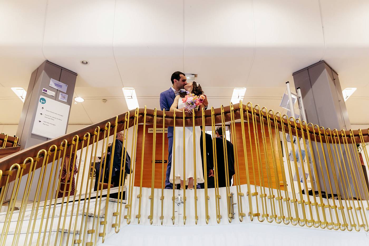 Baiser des mariés en haut des escaliers de la mairie du 17e arrondissement de Paris