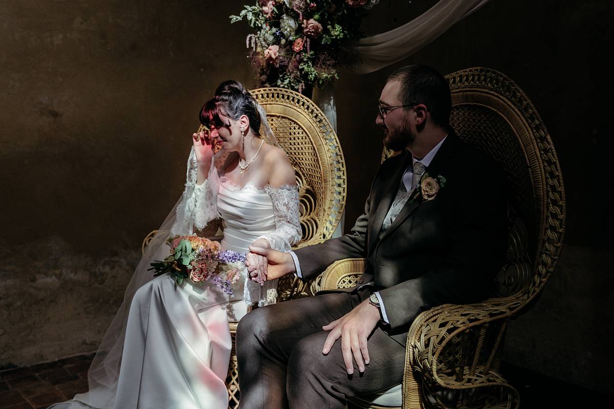 Les mariés main dans la main pendant le discours de la sœur de la mariée.