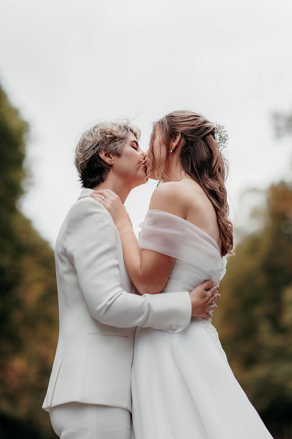 Le baiser des mariées avec la belle symétrie offerte l'allée d'arbres de la plaine Saint-Antoine