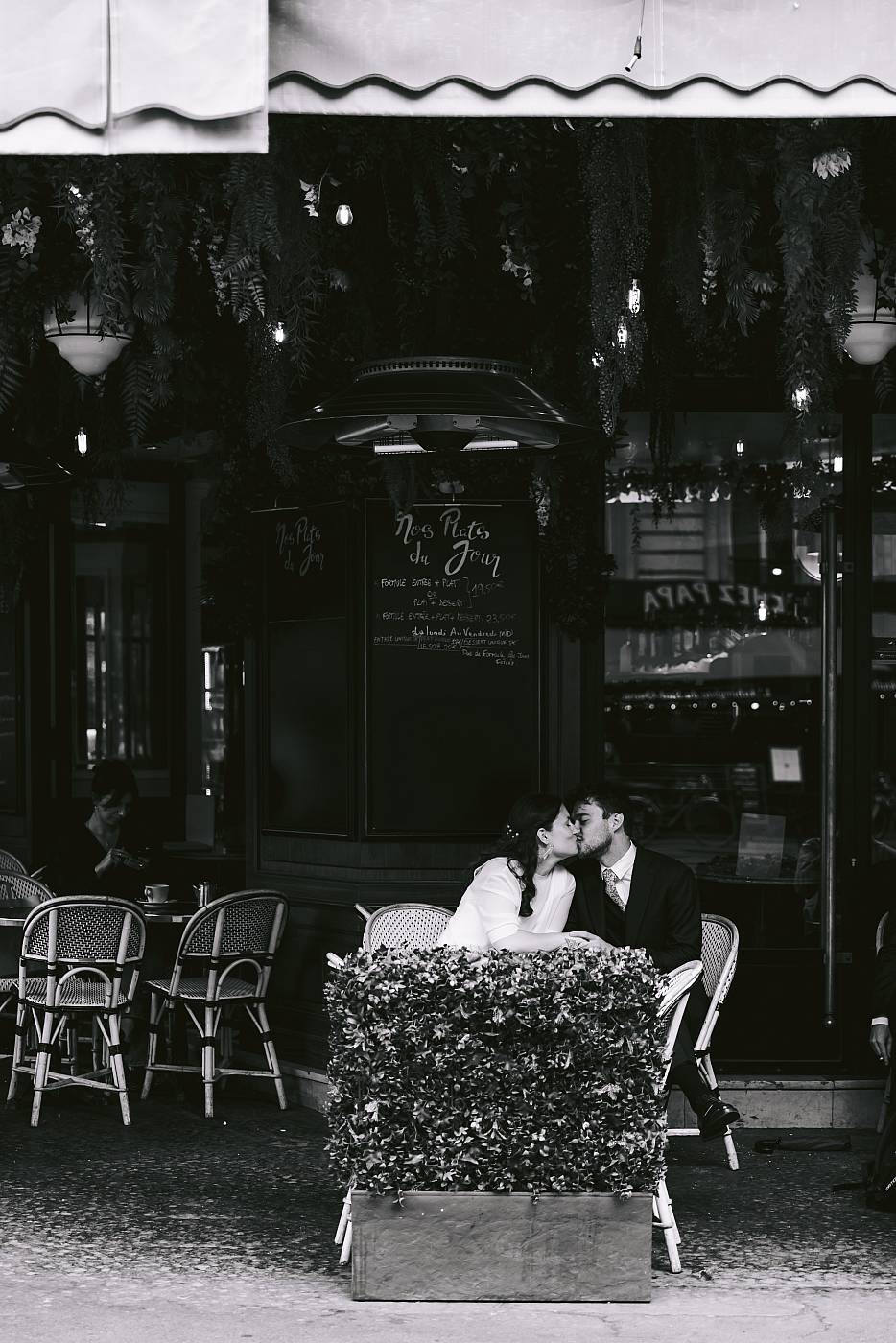 Le baiser des mariés à la terrasse d'un bar pittoresque de Paris