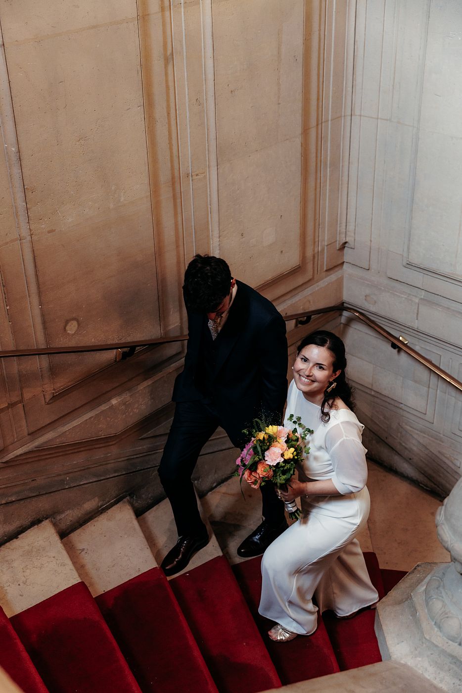 Les mariés dans les escaliers rejoignant la salle des mariages