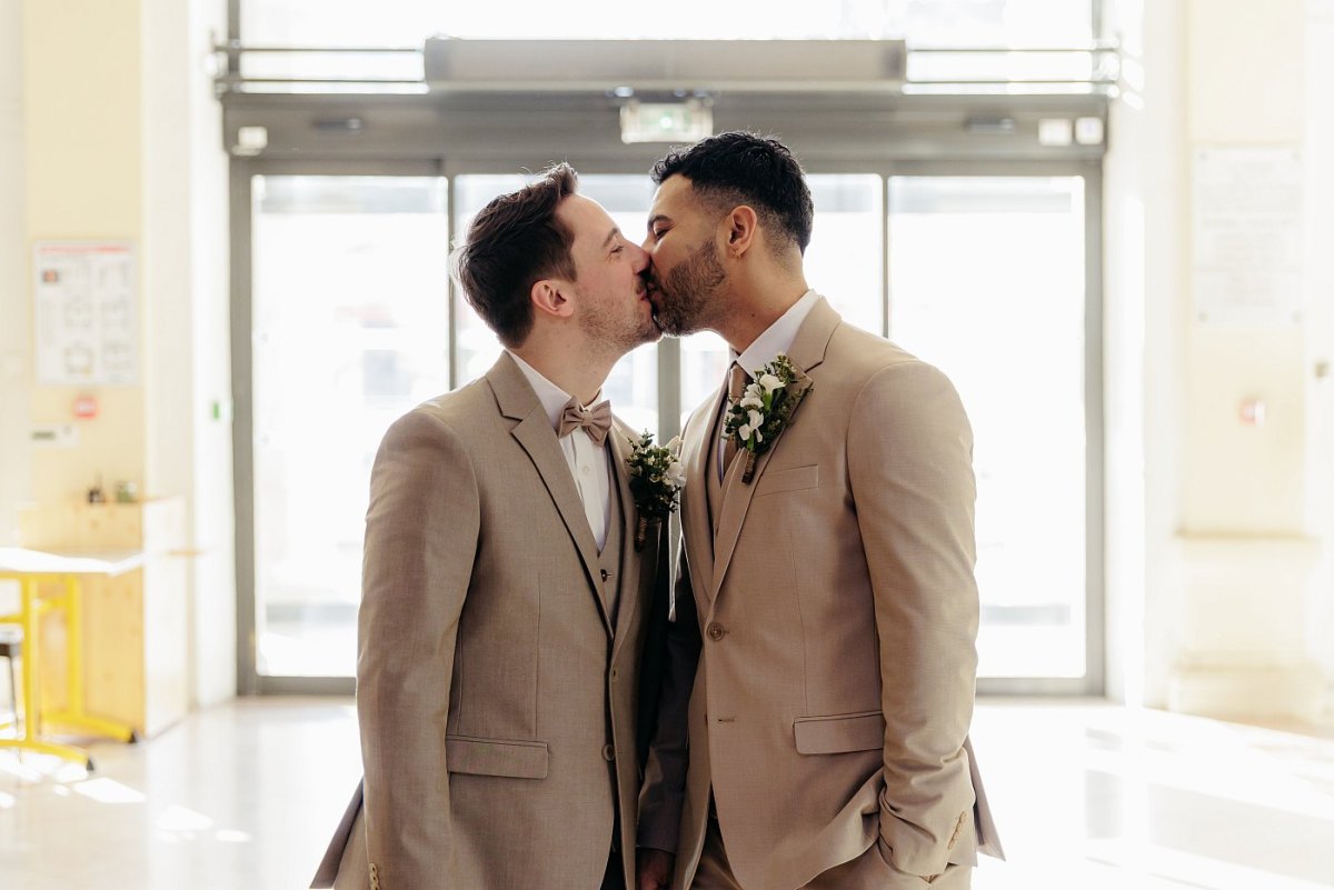 Les mariés s'embrassent avant de rejoindre la salle des mariages